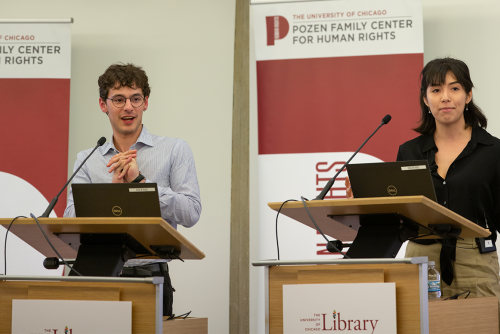 Two people standing at podiums looking out to the audience