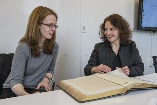 Professor LaCroix and Sheri Lewis examine a old book