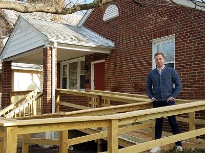 Andrew Parker, '17, in front of one of the properties he rehabbed through his company, Nestidd.