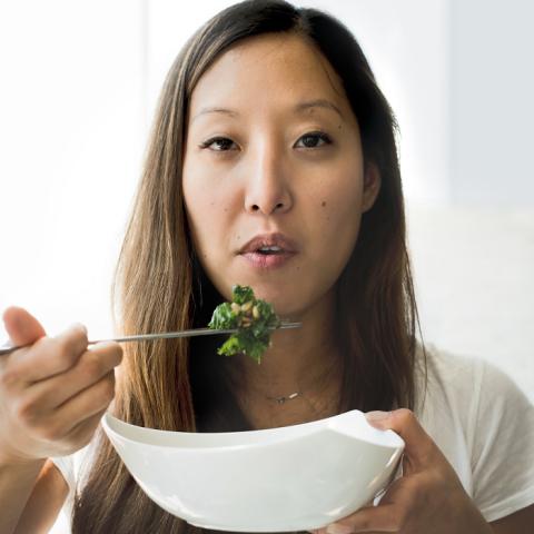 Joanne Lee Molinaro with a bowl of food and chopsticks