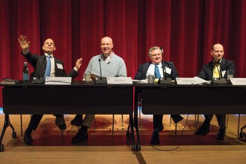 Professors sitting at a table with microphones