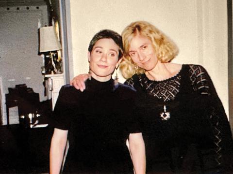 Rachel and Martha wearing all black. Martha's hand is on Rachel's shoulder.