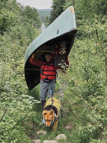 Mohammed Kredan and his dog with a canoe.