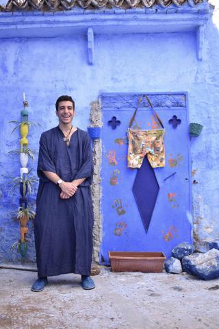 Mohammed Kredan posing in front of a blue wall
