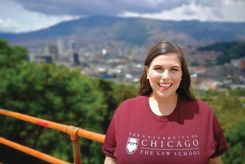 Samantha Sherman standing near a yellow railing with a blurred city background