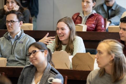 A student asks a question from her seat in the classroom