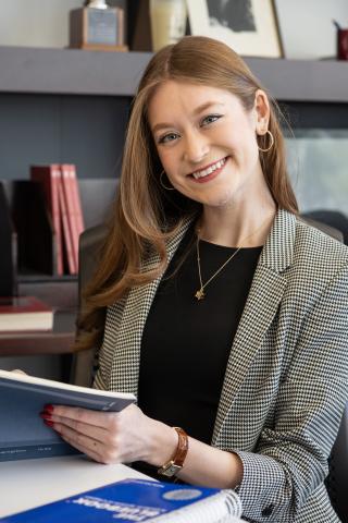 Woman sitting at a desk smiling at the camera