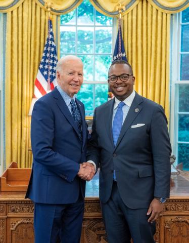 President Biden shakes hands with William Godwin in the Oval Office