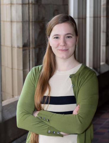 Lucy Msall, standing with hands folded