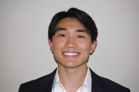 A close-up photo of Sam Oh smiling