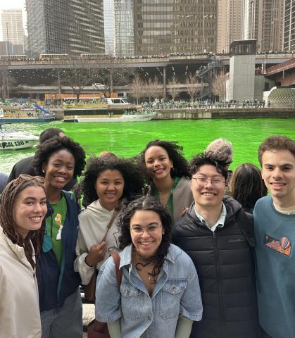 Saralyn Carcy with group in front of Chicago River, dyed green for Saint Patrick's Day celebration