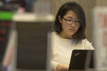 A student works on her laptop