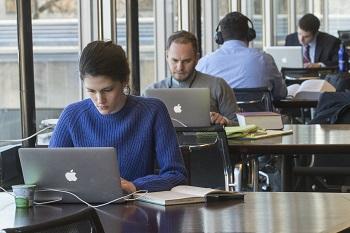 A row of students studying in the library