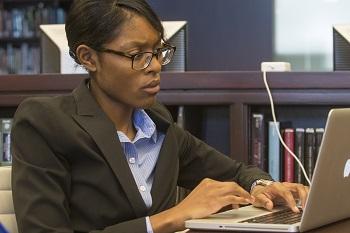 A student works on her laptop in the library