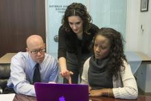 Futterman, Miller, and student Ruby Garrett sit around a single laptop