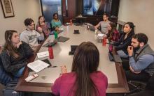 Nicole Hallett and students seated around a table