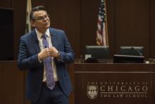 Professor Adam Chilton makes a point as he speaks in the Law School courtroom