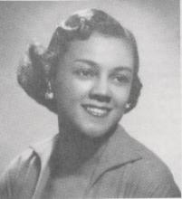 Headshot of a woman smiling and looking to the side