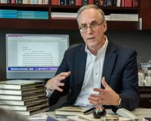 Curtis Bradley gestures at his desk.