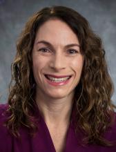 A headshot of a woman smiling