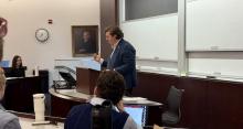 Will Baude standing at lecturn, speaking