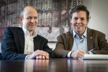Prof. Bray and Prof. Baude sit at a conference table side by side.