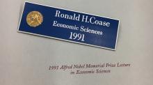 Coase's name tag and lecture from the Nobel events. 