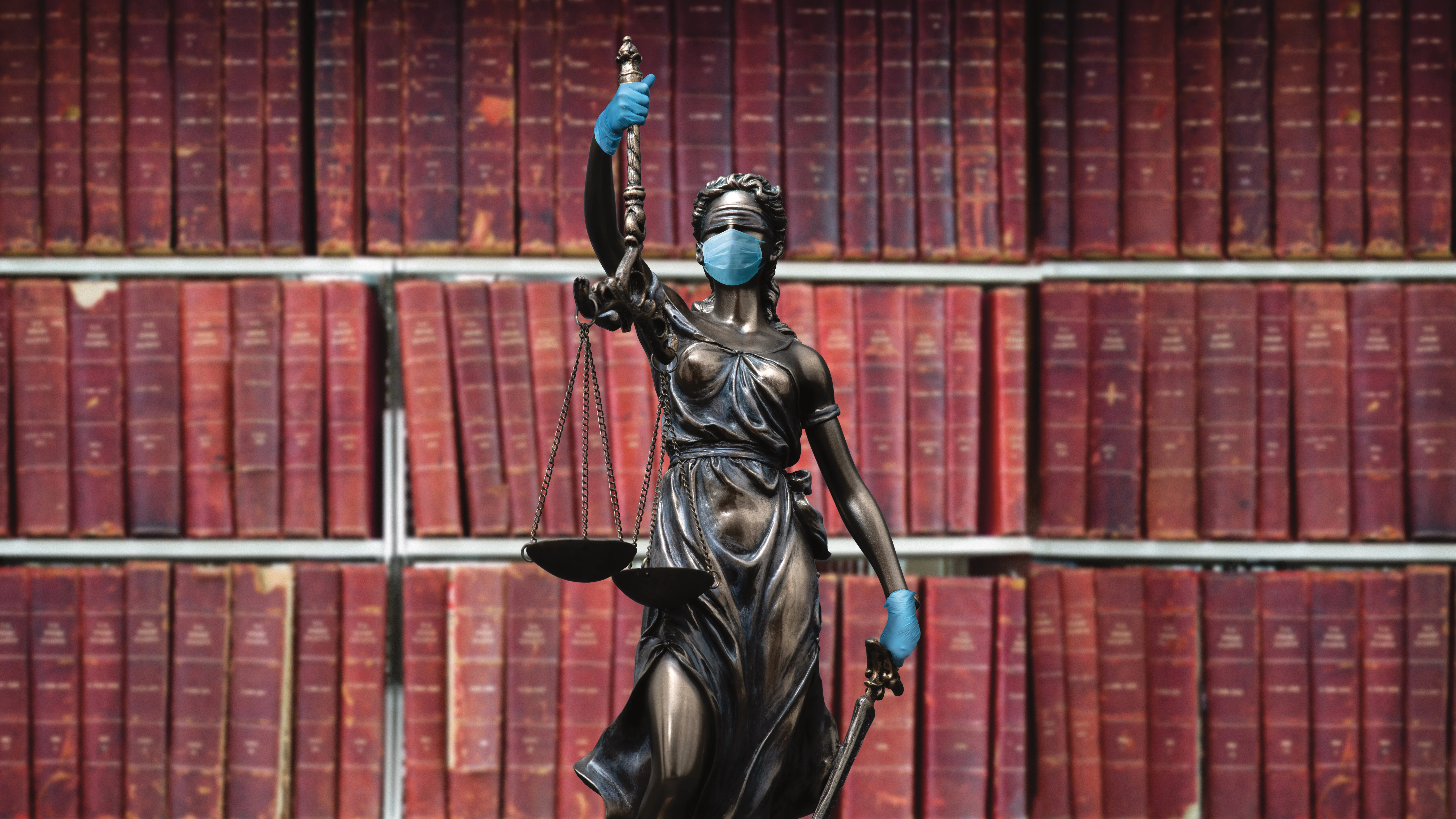 Scales of justice wearing PPE