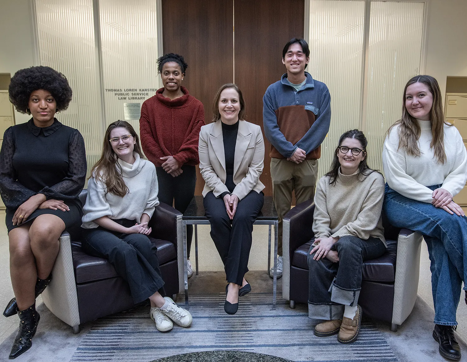 Erica Zunkel and her students seated together to pose for a photo.