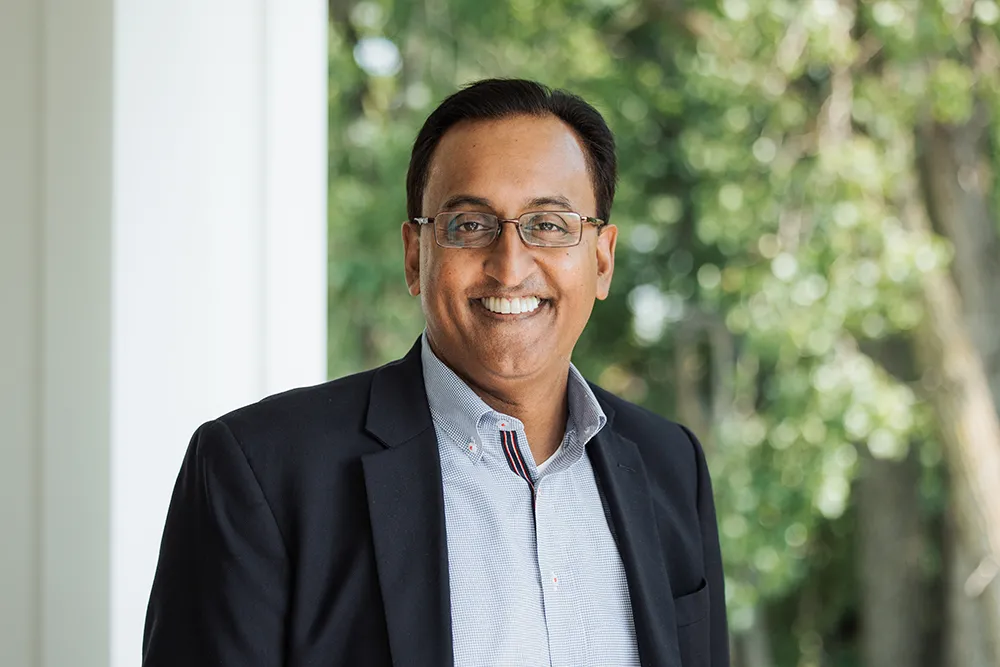 Headshot of Prasad wearing a suit