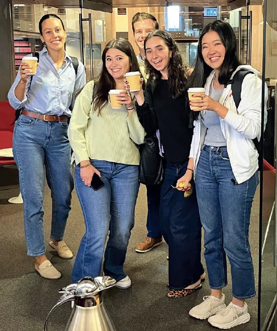 Group of students holding coffee.
