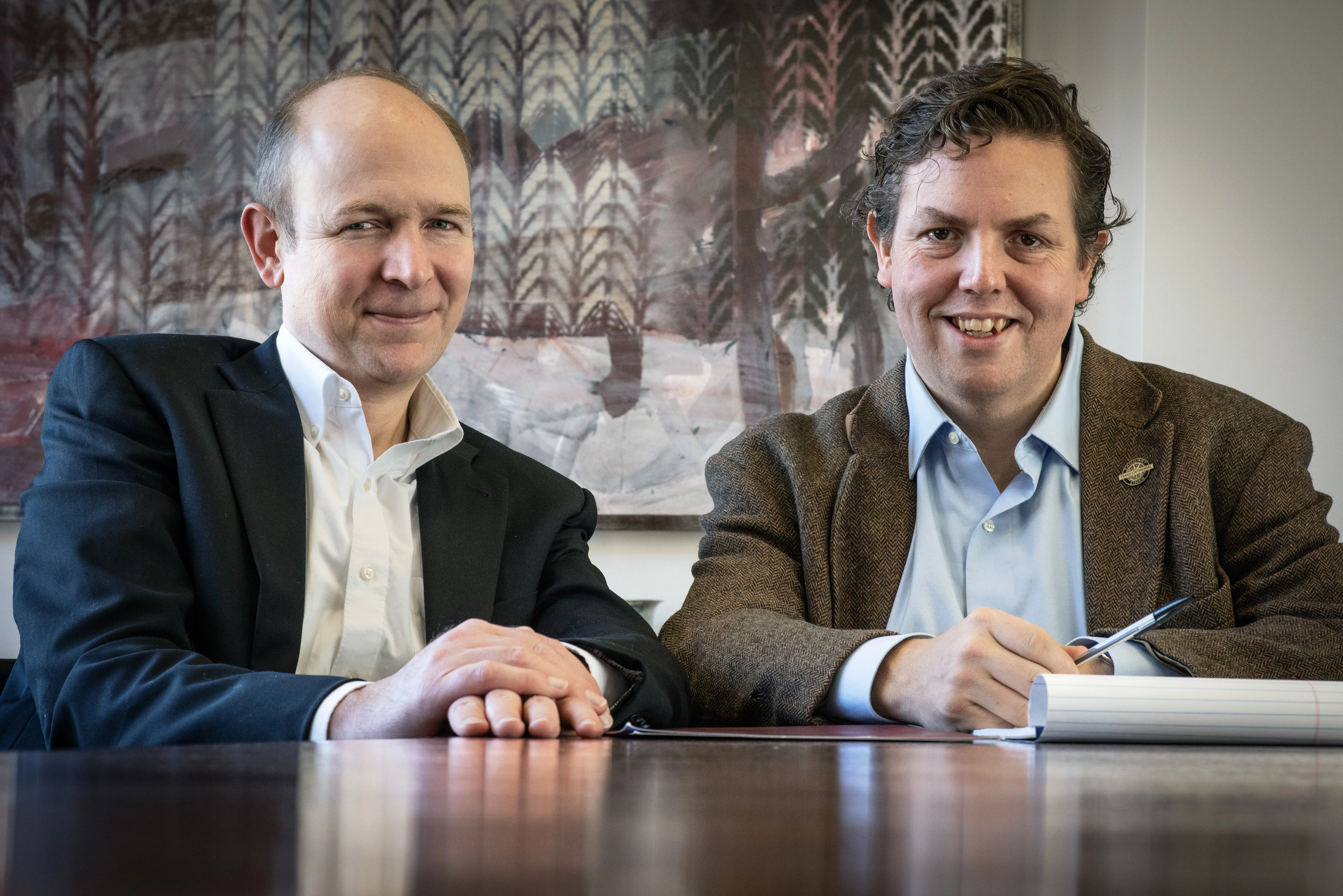 Prof. Bray and Prof. Baude sit at a conference table side by side.