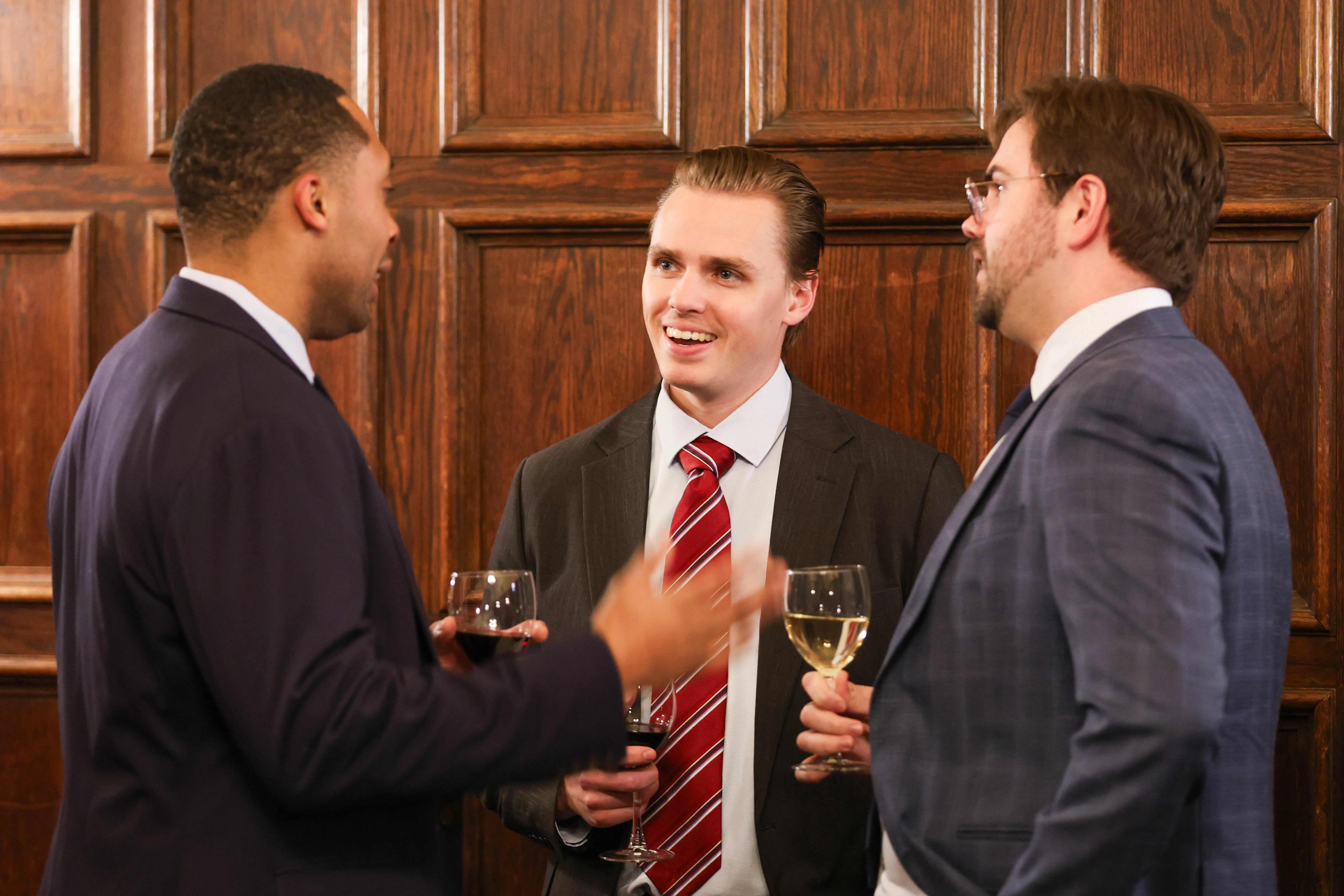 Three students speak cordially at the Midway Dinner.
