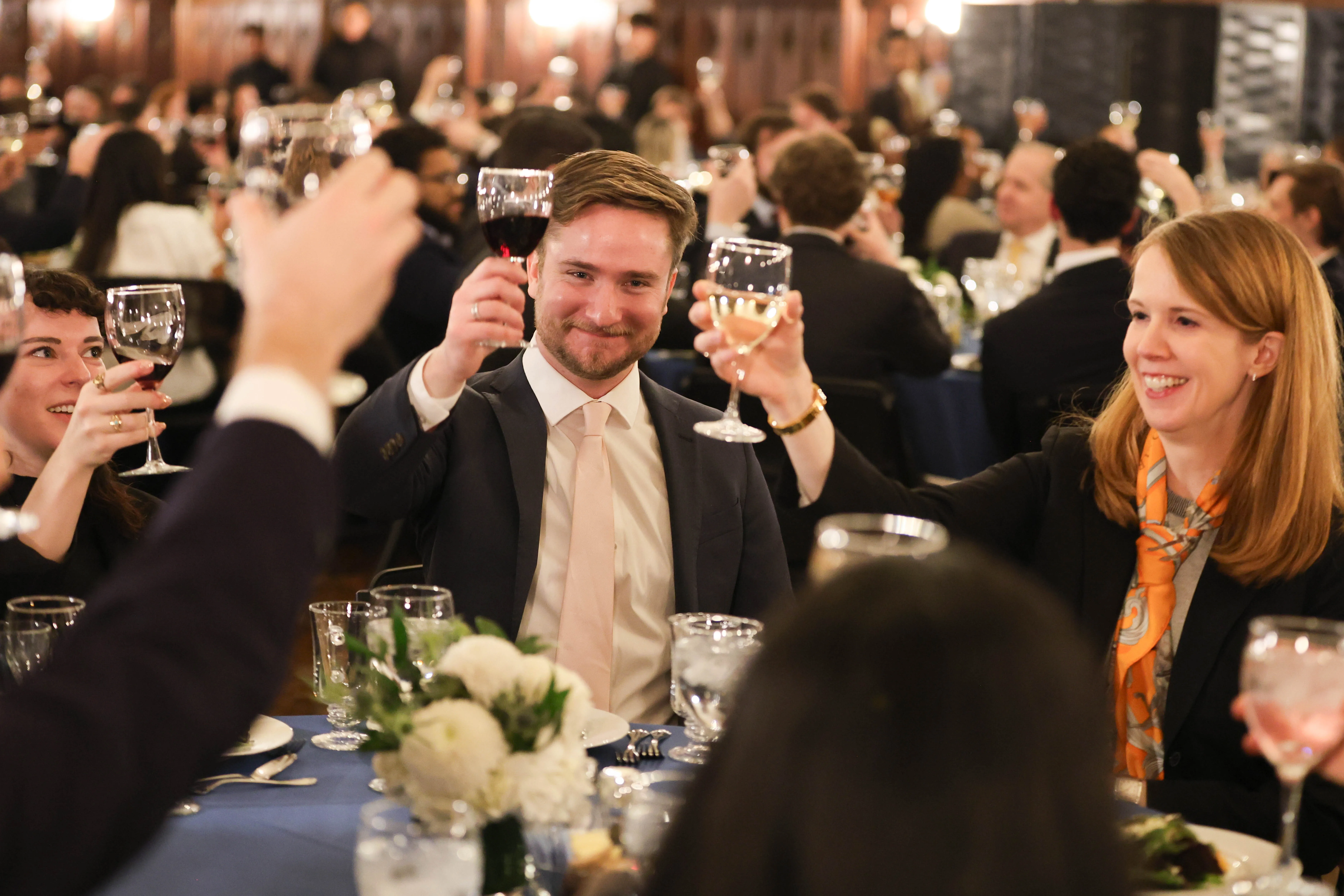 Students at the Midway Dinner raise glasses in celebration.